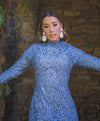 Woman wearing modest fitted blue floral lace gown with long sleeves.