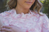 Close up of butterfly detaling on blush pink modest gown 