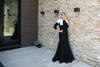 Modest black mermaid gown with white feathered shoulders
