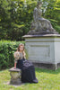 Girl wearing modest black gown with gold top overlay cut from glamorous mini sequin and glitter, and voluminous puffed sleeves. Black feather peplum waist detail.