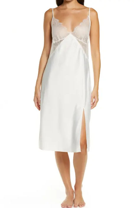 Woman wearing white ethereal chemise with lacy trim and a flowy tulip skirt.